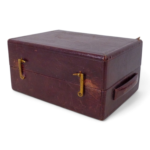 87 - A late 19th century maroon leather jewellery box - with a double hinged cover opening to reveal a ve... 