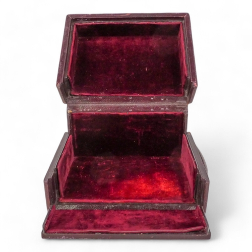 87 - A late 19th century maroon leather jewellery box - with a double hinged cover opening to reveal a ve... 