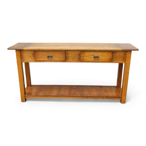 950 - A 19th century style serving table - the cleated plank top above two frieze drawers, on square taper... 