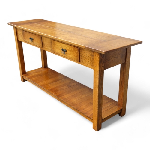 950 - A 19th century style serving table - the cleated plank top above two frieze drawers, on square taper... 