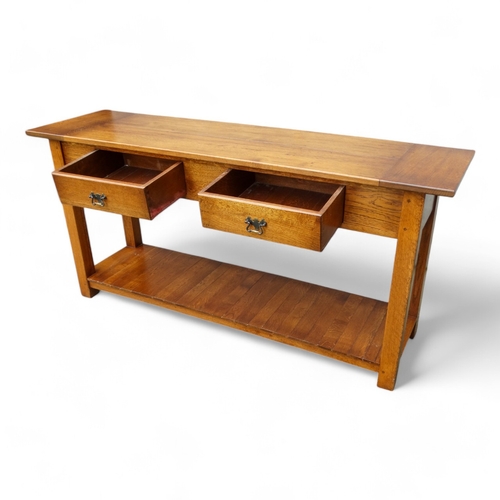 950 - A 19th century style serving table - the cleated plank top above two frieze drawers, on square taper... 