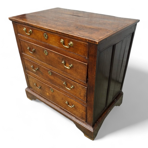 951 - A late George II oak chest of drawers - with an arrangement of four graduated drawers and panelled s... 