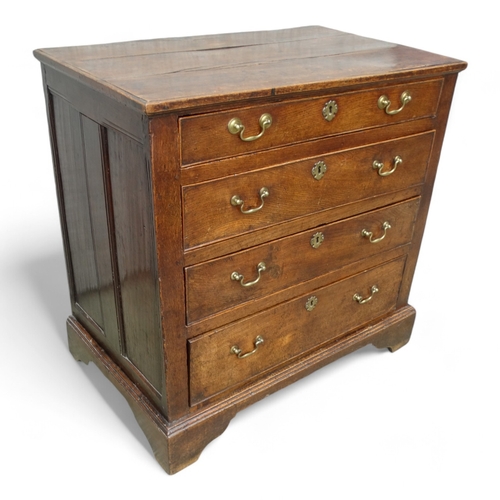 951 - A late George II oak chest of drawers - with an arrangement of four graduated drawers and panelled s... 