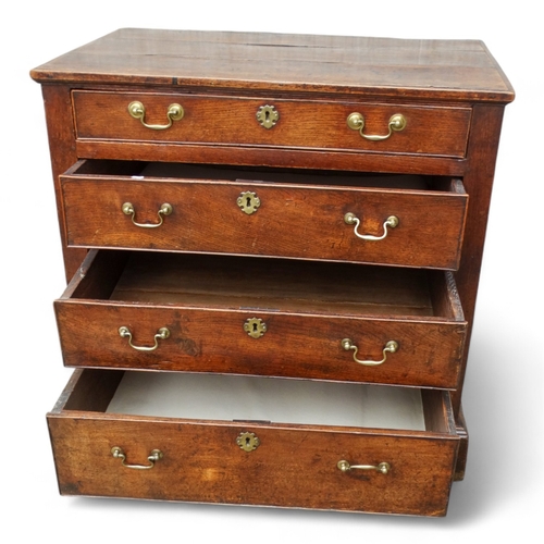 951 - A late George II oak chest of drawers - with an arrangement of four graduated drawers and panelled s... 