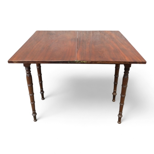 953 - A George IV mahogany tea table - the rectangular top on a swivelling frame on turned tapering legs, ... 