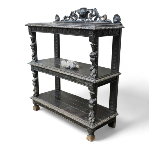 954 - A 17th century style oak buffet - with a pierced and carved raised back above three rectangular tier... 