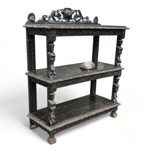 954 - A 17th century style oak buffet - with a pierced and carved raised back above three rectangular tier... 