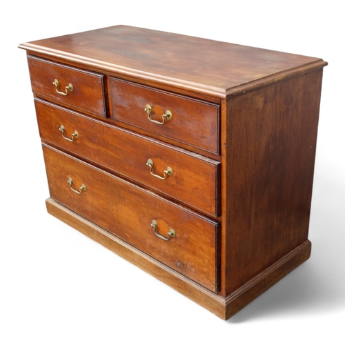 955 - An Edwardian mahogany chest of drawers - the rectangular top above an arrangement of two short and t... 