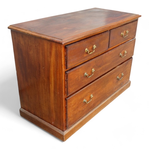 955 - An Edwardian mahogany chest of drawers - the rectangular top above an arrangement of two short and t... 