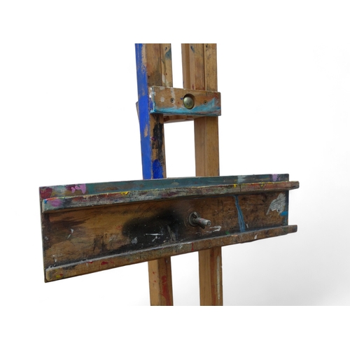 957 - A 20th century beech artist's studio easel - of folding tripod form with some paint transfer, fully ... 