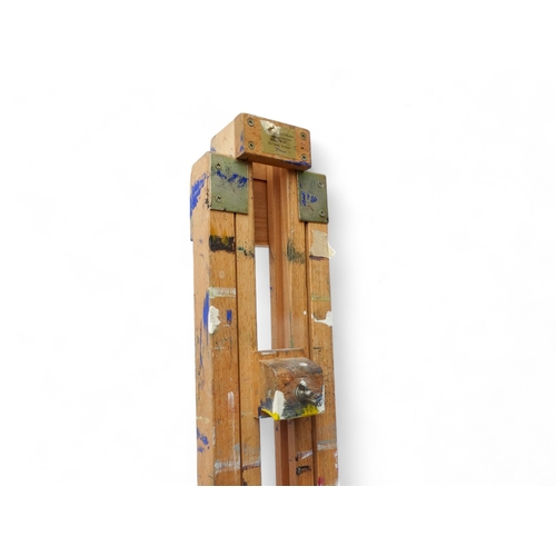 957 - A 20th century beech artist's studio easel - of folding tripod form with some paint transfer, fully ... 