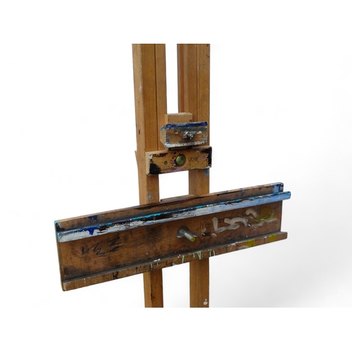 958 - A 20th century beech artist's studio easel - of folding tripod form with some paint transfer, fully ... 