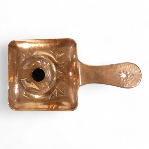 1 - A Newlyn copper chamber stick - with a square pan and circular sconce repousse decorated with fish, ... 