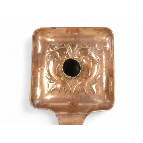 1 - A Newlyn copper chamber stick - with a square pan and circular sconce repousse decorated with fish, ... 