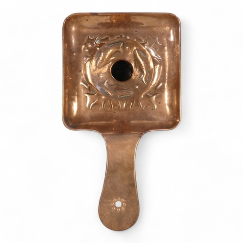 1 - A Newlyn copper chamber stick - with a square pan and circular sconce repousse decorated with fish, ... 