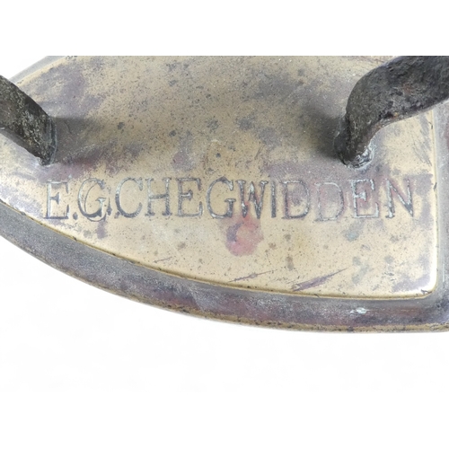 108 - A late 19th century flat iron - stamped E G Chegwidden, 14cm high.