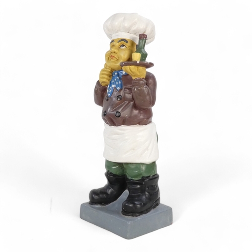 114 - A 20th century plaster cast figure - in the form of a quizzical chef holding a drinks tray, 51cm hig... 