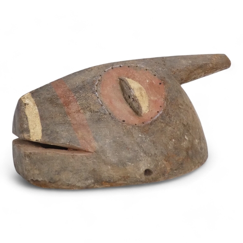 117 - A polychrome painted tribal African mask - with red eye sockets and drilled border, together with a ... 