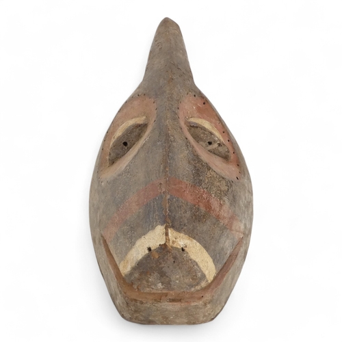 117 - A polychrome painted tribal African mask - with red eye sockets and drilled border, together with a ... 