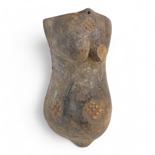 118 - A tribal African fertility carving - the female figure with engorged belly, 36cm high.