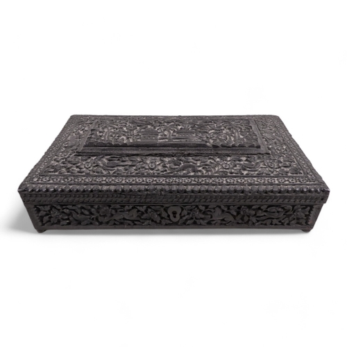 12 - An Anglo Indian glove box - extensively carved with flowers and foliage, including a temple scene, 2... 