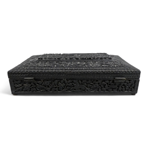 12 - An Anglo Indian glove box - extensively carved with flowers and foliage, including a temple scene, 2... 