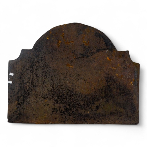 135 - An 18th century cast iron fire back - rectangular with an arched top and cast with armorial amongst ... 