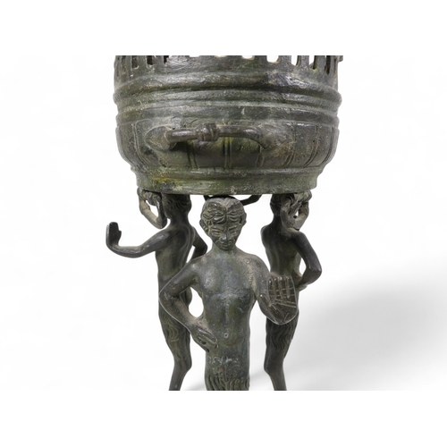 137 - A 19th century bronze torchiere - the cauldron on three faun supports, 26cm high.