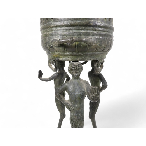 137 - A 19th century bronze torchiere - the cauldron on three faun supports, 26cm high.