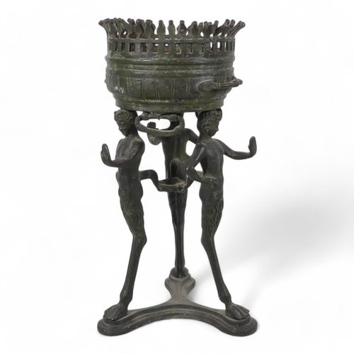 137 - A 19th century bronze torchiere - the cauldron on three faun supports, 26cm high.