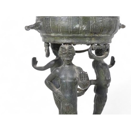 137 - A 19th century bronze torchiere - the cauldron on three faun supports, 26cm high.