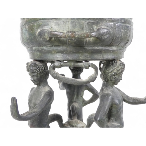 137 - A 19th century bronze torchiere - the cauldron on three faun supports, 26cm high.