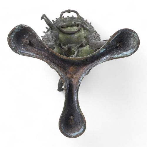 137 - A 19th century bronze torchiere - the cauldron on three faun supports, 26cm high.