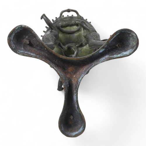 137 - A 19th century bronze torchiere - the cauldron on three faun supports, 26cm high.