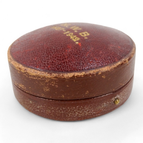 15 - A mid 20th century ballooning barometer - retailed by Harrods, in a red leather case, 6cm diameter.