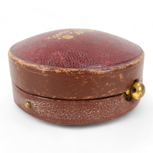 15 - A mid 20th century ballooning barometer - retailed by Harrods, in a red leather case, 6cm diameter.