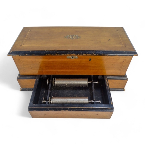 16 - A late 19th century cylinder music box - the rectangular walnut case with stringing and stencilled d... 