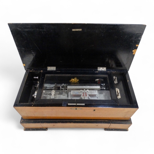 16 - A late 19th century cylinder music box - the rectangular walnut case with stringing and stencilled d... 