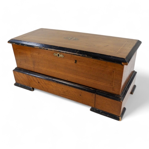 16 - A late 19th century cylinder music box - the rectangular walnut case with stringing and stencilled d... 