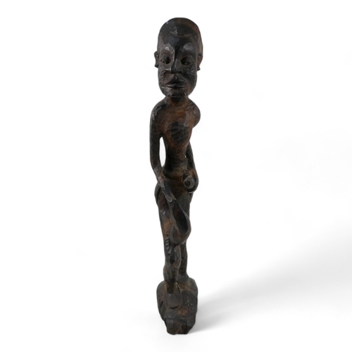 17 - A 20th century carved figure of an African warrior - 65cm high, together with four carved hardwood A... 