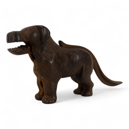 20 - A set of early 20th century iron nut crackers - modelled in the form of a dog, 24cm wide, together w... 