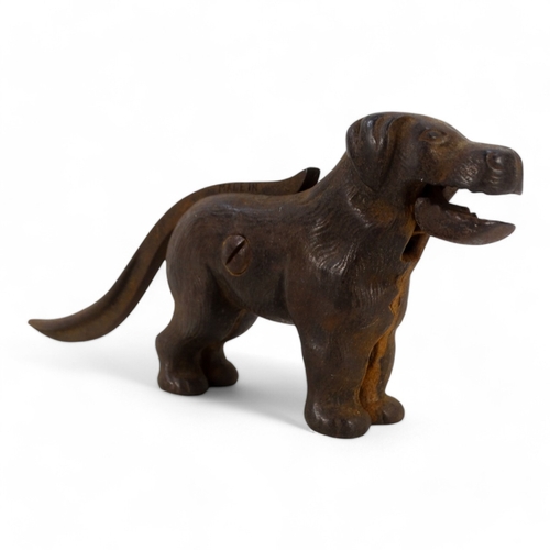 20 - A set of early 20th century iron nut crackers - modelled in the form of a dog, 24cm wide, together w... 