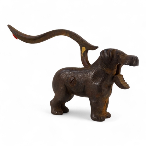 20 - A set of early 20th century iron nut crackers - modelled in the form of a dog, 24cm wide, together w... 