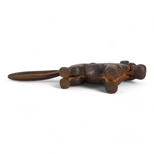 20 - A set of early 20th century iron nut crackers - modelled in the form of a dog, 24cm wide, together w... 