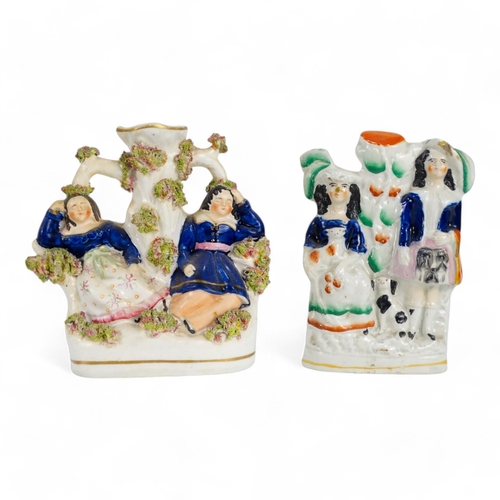 213 - A late 19th century Staffordshire spill holder - modelled as a couple seated below a tree, 15cm high... 