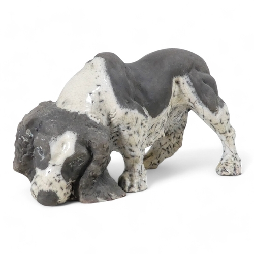 237 - Keza Rudge (British 20th/21st Century) - a spaniel picking up a scent, with raku glaze, signed to un... 