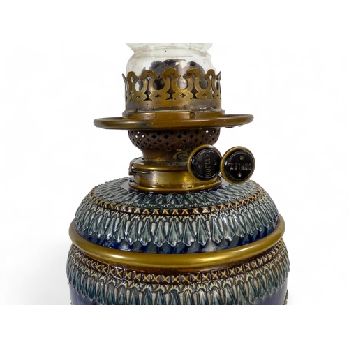 246 - A Lambeth Doulton stoneware oil lamp - with stylised foliate form with brass fittings, 52cm high.