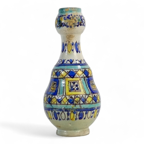 250 - An Isnik vase - of baluster form with a geometric decoration, 22cm high.