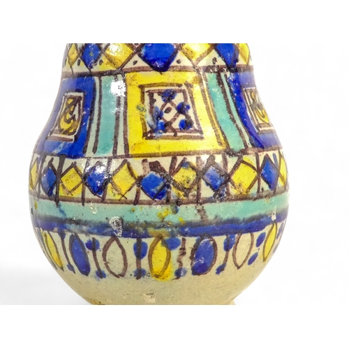 250 - An Isnik vase - of baluster form with a geometric decoration, 22cm high.