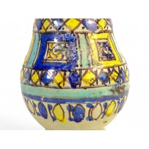 250 - An Isnik vase - of baluster form with a geometric decoration, 22cm high.